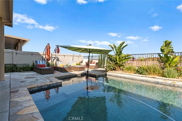 view of swimming pool with an outdoor living space and a patio area