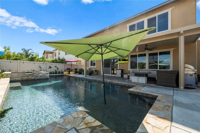 view of swimming pool with ceiling fan, outdoor lounge area, a patio, and an in ground hot tub