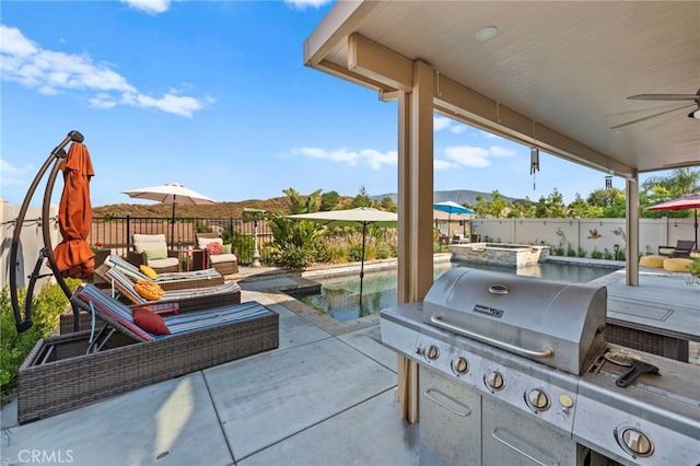 view of patio featuring ceiling fan, a pool with hot tub, a mountain view, and a grill