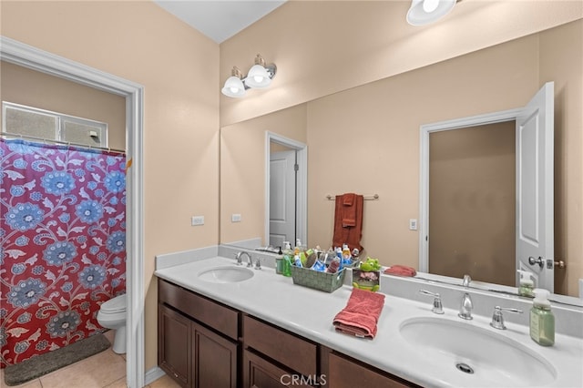 bathroom featuring toilet, tile patterned floors, vanity, and curtained shower