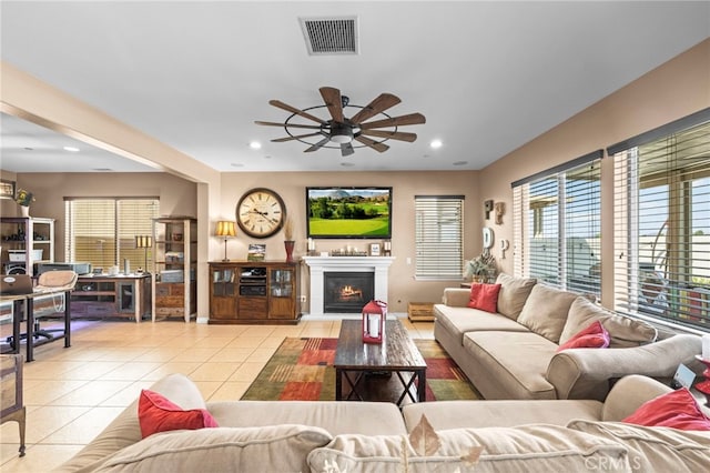 tiled living room with ceiling fan