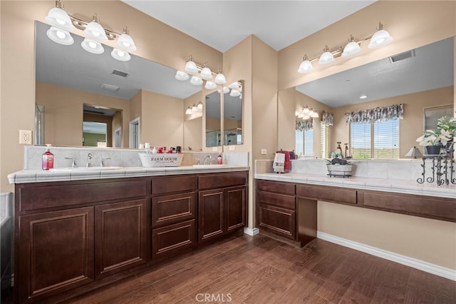 bathroom featuring decorative backsplash, wood-type flooring, and vanity