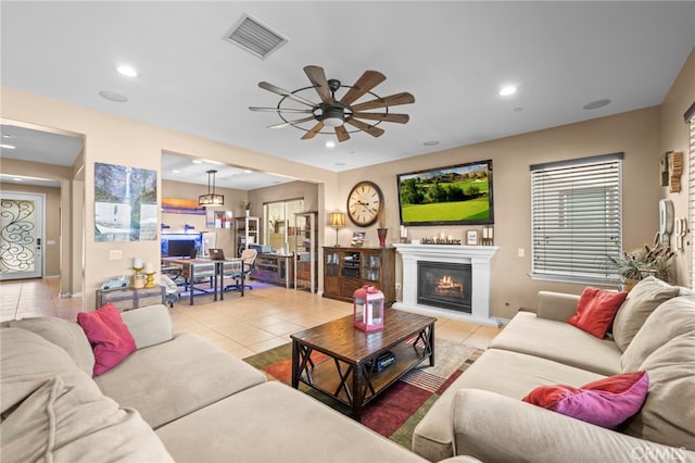 living room with ceiling fan and light tile patterned floors