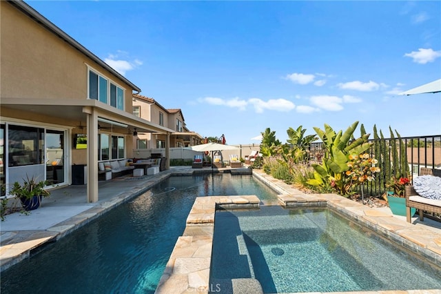 view of pool with ceiling fan, a patio area, and an in ground hot tub