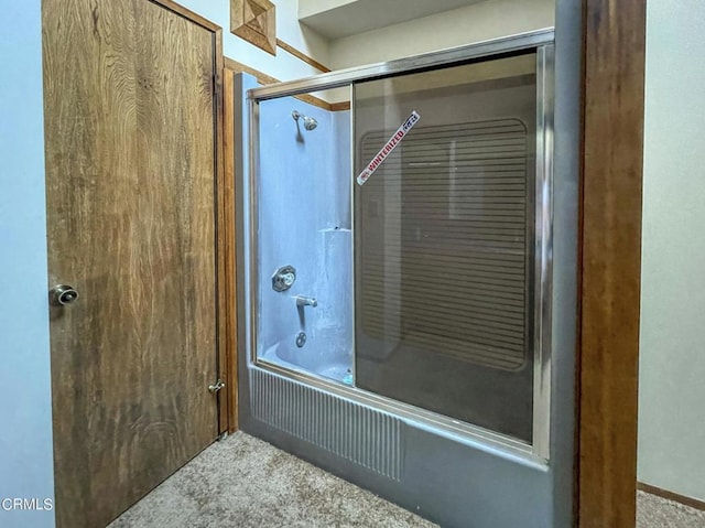 bathroom with shower / bath combination with glass door