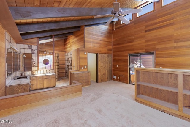 interior space with carpet floors, high vaulted ceiling, wooden walls, ceiling fan, and wood ceiling