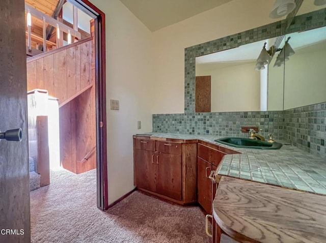 bathroom featuring vanity and tasteful backsplash