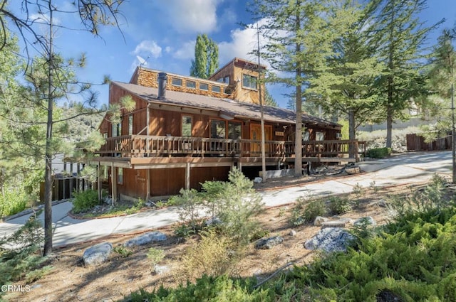 rear view of property featuring a deck