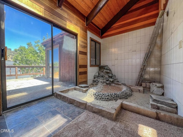 unfurnished sunroom with lofted ceiling with beams and wood ceiling