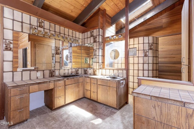 bathroom featuring sink, vaulted ceiling with beams, wood walls, and wood ceiling