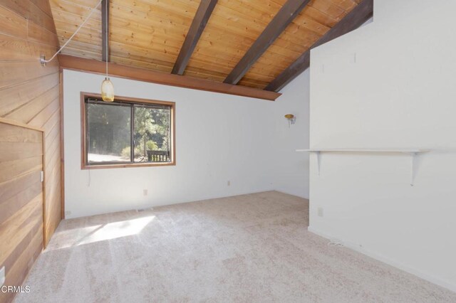 unfurnished living room featuring vaulted ceiling with beams, wooden ceiling, and light carpet