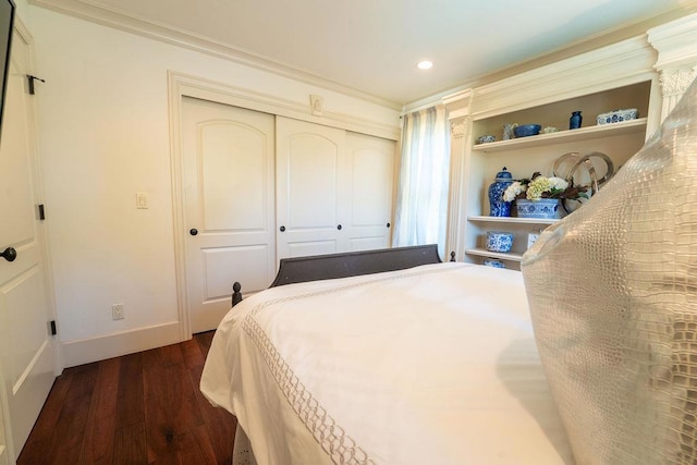 bedroom with a closet and dark hardwood / wood-style floors