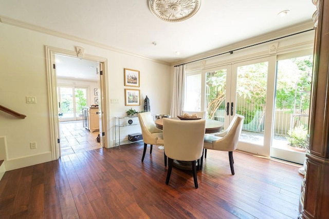 dining room with crown molding, french doors, and dark wood-type flooring