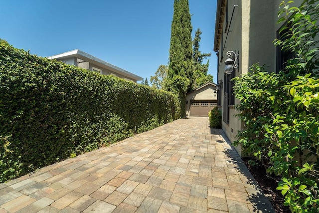 view of patio / terrace with a garage and an outdoor structure