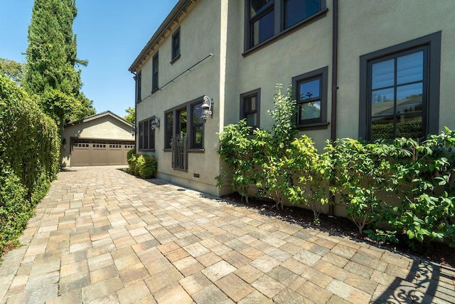 view of patio featuring a garage and an outdoor structure