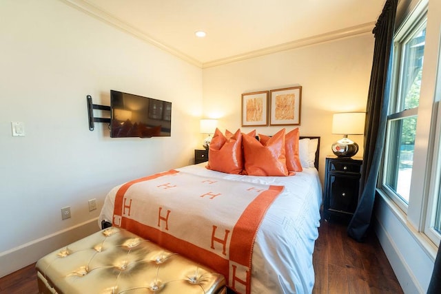 bedroom featuring crown molding and dark wood-type flooring