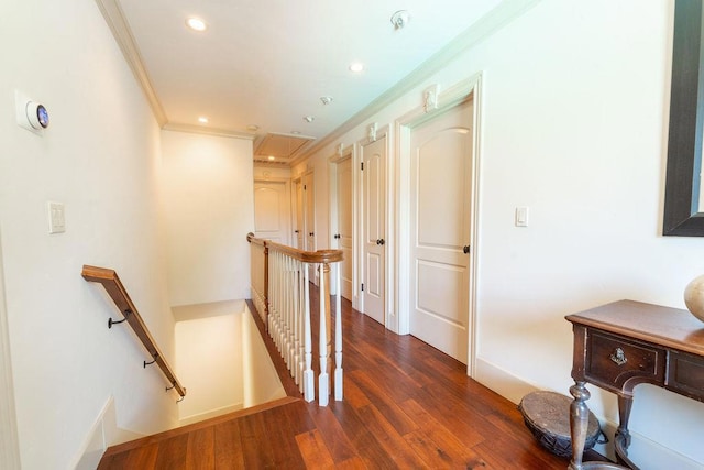 hallway with ornamental molding and dark wood-type flooring