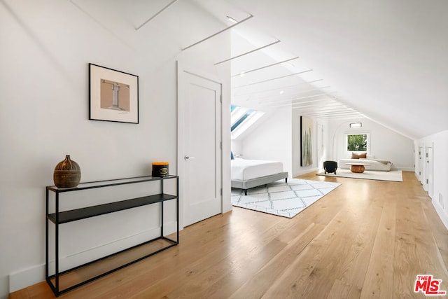 additional living space featuring lofted ceiling and wood-type flooring