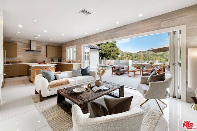 living room with sink and light tile patterned floors