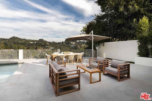 view of patio featuring a fenced in pool