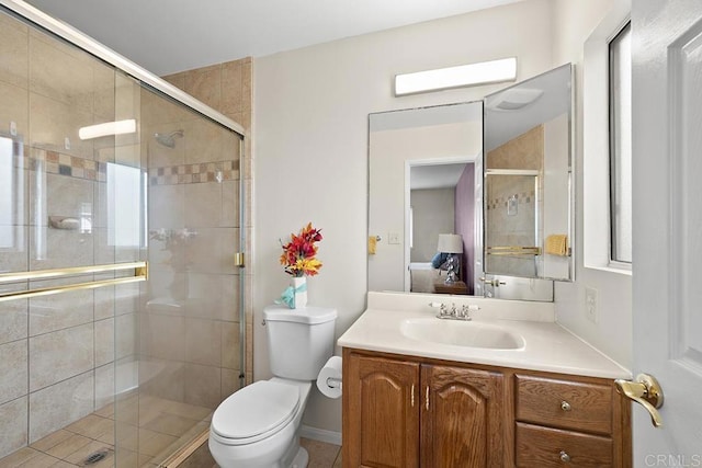 bathroom featuring vanity, an enclosed shower, and toilet