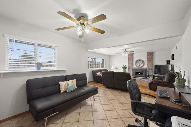 tiled office featuring a large fireplace, plenty of natural light, and ceiling fan