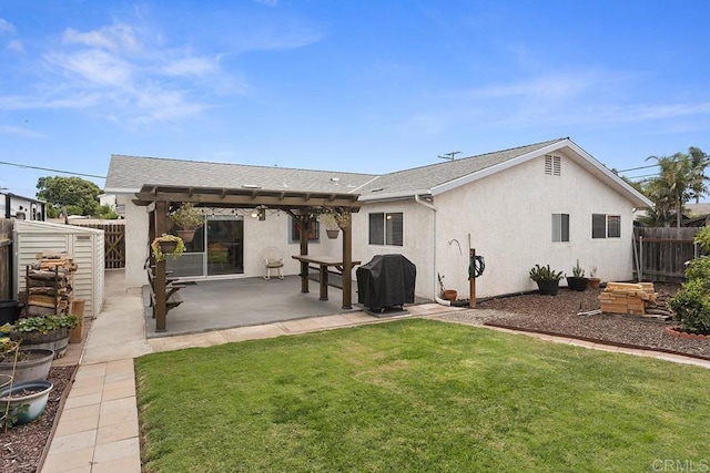 rear view of property featuring a lawn and a patio