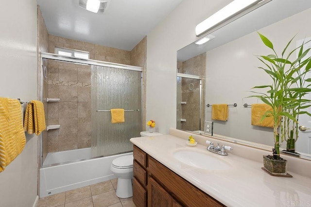 full bathroom with tile patterned flooring, vanity, toilet, and shower / bath combination with glass door