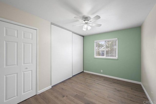 unfurnished bedroom featuring hardwood / wood-style flooring and ceiling fan