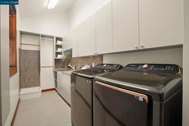 washroom featuring cabinets, independent washer and dryer, and sink