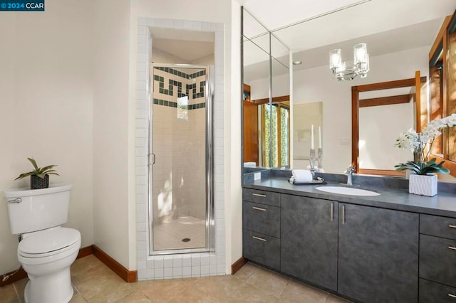 bathroom with tile patterned floors, toilet, vanity, and walk in shower