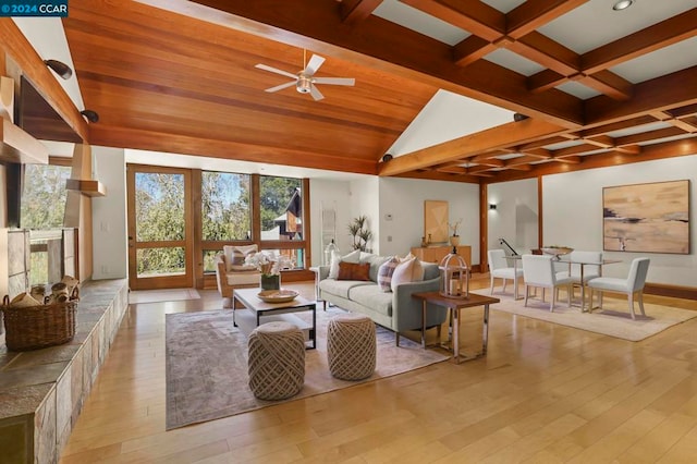 living room with beamed ceiling, light hardwood / wood-style flooring, and ceiling fan