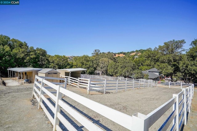 view of yard with an outbuilding and a rural view