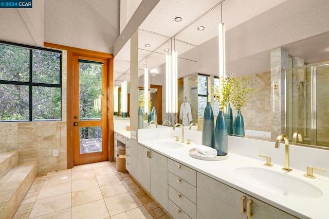 bathroom with tile patterned floors, vanity, and walk in shower