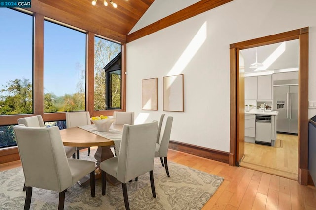 dining room with wood ceiling, ceiling fan, light hardwood / wood-style floors, and lofted ceiling