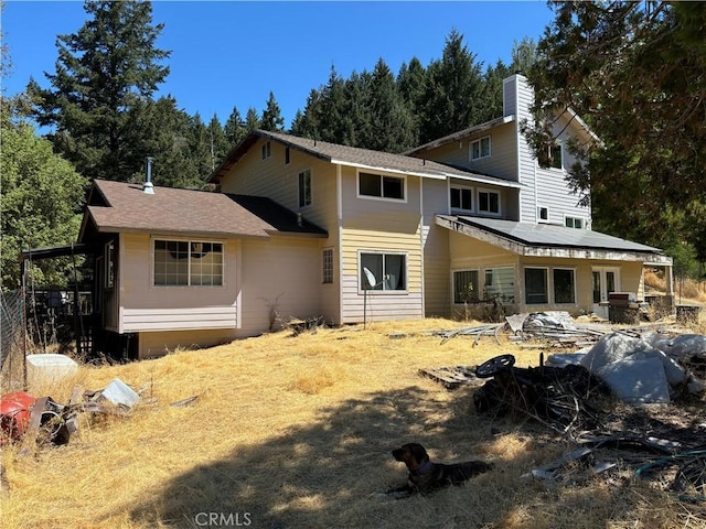 rear view of property with solar panels