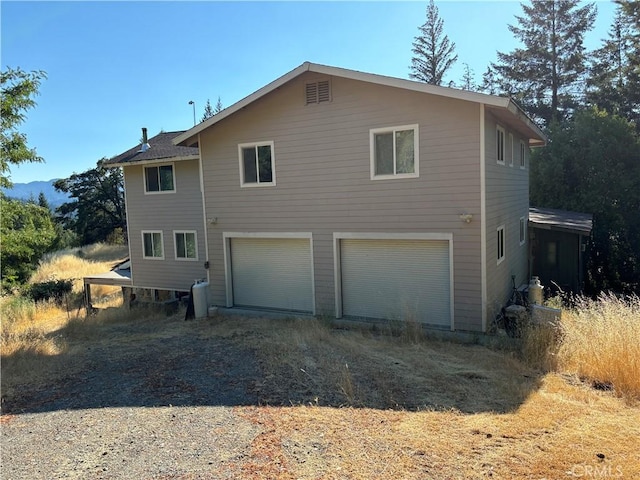 view of side of home featuring a garage