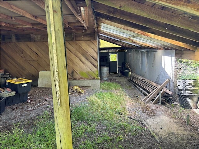 interior space with wood walls and vaulted ceiling