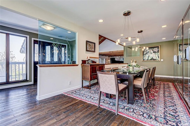 dining space featuring a chandelier, dark hardwood / wood-style flooring, and crown molding