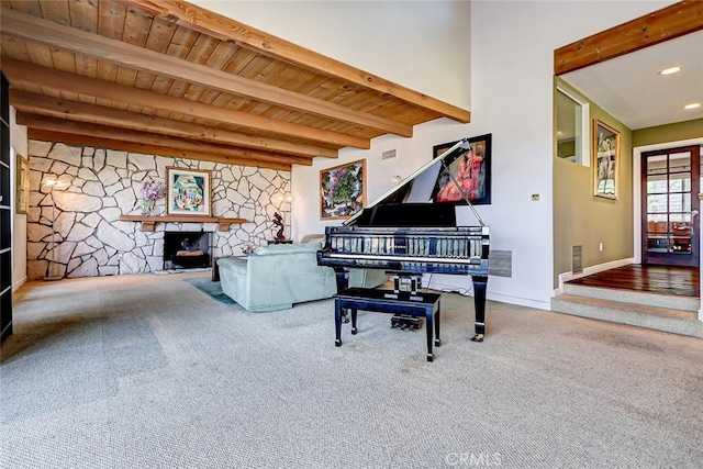 miscellaneous room featuring beam ceiling, wooden ceiling, a fireplace, and carpet floors