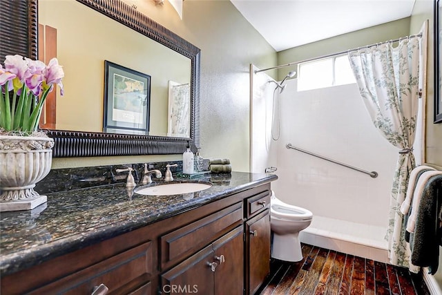 bathroom with a shower with shower curtain, vanity, wood-type flooring, and toilet