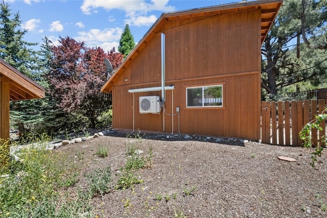 view of side of home with ac unit