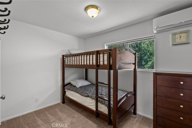 14329 Voltaire Dr, Pine Mountain Club, CA 93225 - carpeted bedroom with baseboards and a wall unit AC