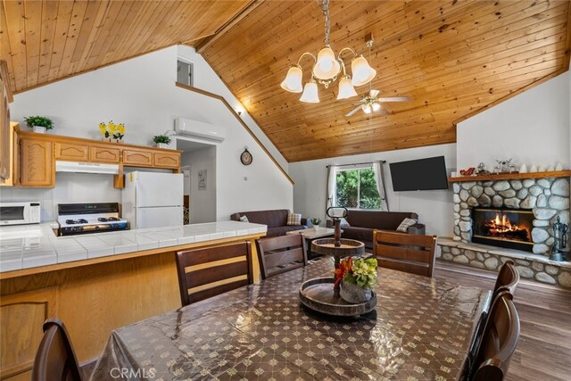 14329 Voltaire Dr, Pine Mountain Club, CA 93225 - dining space with wood finished floors, a fireplace, wood ceiling, a wall unit AC, and ceiling fan with notable chandelier