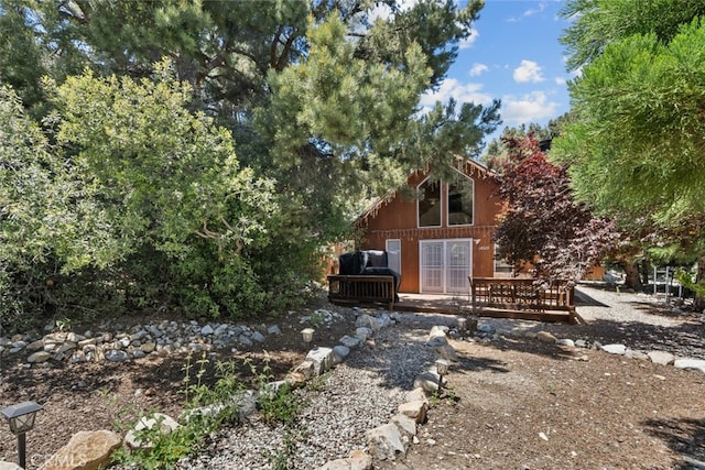 back of house with a wooden deck