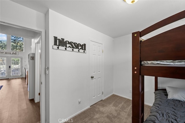 carpeted bedroom featuring french doors