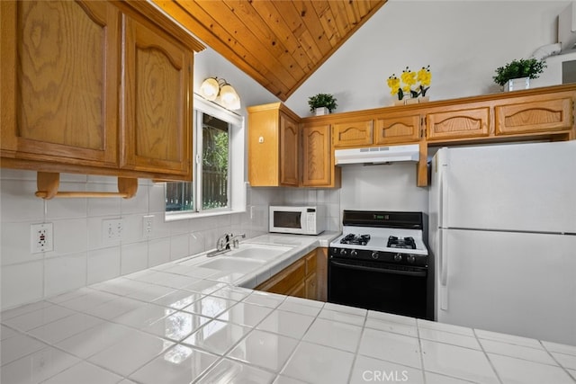 kitchen featuring lofted ceiling, wood ceiling, sink, white appliances, and tile counters