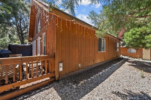 view of side of property featuring a deck