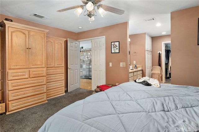 bedroom featuring connected bathroom, ceiling fan, and dark carpet