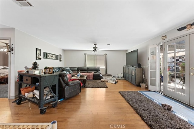 living room featuring ceiling fan and light wood-type flooring